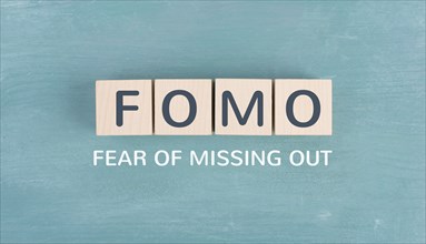 FOMO acronym for fear of missing out, social media and lifestyle concept, regret and depression,