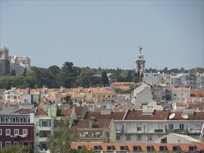 View of a city with many roofs, buildings and hills in the background in Portugal, Lisbon, portugal