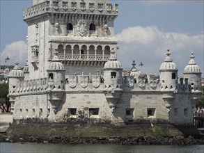 Close-up of a stone watchtower with detailed architecture on the waterfront, Lisbon, portugal