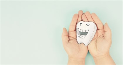 White tooth with a smiling face and thumbs up, dental health, teeth hygiene, medical concept