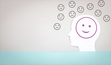 Head with a happy smiling face surrounded by sad people, mental health concept, positive and