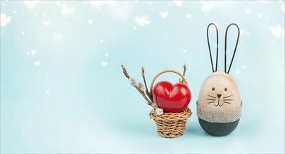 Wicker basket with a big red heart and an easter bunny, rabbit brings gift of love, greeting card