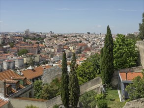 View of a cityscape covered with red roofs, surrounded by trees and hills, Lisbon, portugal