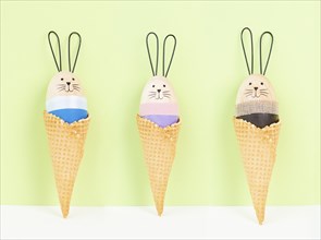 Cute easter bunny or rabbit in an ice cream cone, spring holiday, greeting card