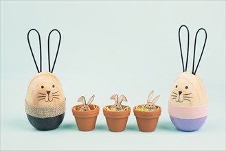 Cute easter bunny family, rabbit baby in a flower pot, spring holiday greeting card