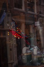 A colourful glass lamp in the shape of a parrot in an antique shop, Amsterdam, Netherlands