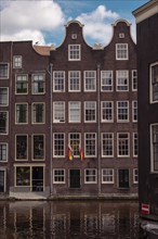 Historic house facades along a canal, Amsterdam, Netherlands