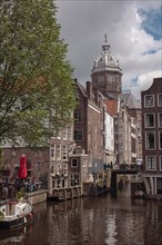 City view with a ship in the canal and old buildings, Amsterdam, Netherlands