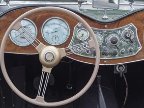 Interior view of a classic car with detailed dashboard and classic steering wheel, winterswijk,