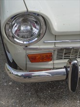 Close-up of a vintage car, showing the front headlight and part of the bumper, winterswijk,