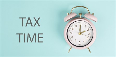 Tax time, alarm clock for taxation, deadline for payment, financial income