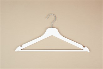 White hanger on a pastel background, fashion store, minimalism clothes, discount promotion