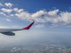 View from aircraft window of upwardly curved extended wing wing tip for better flow behaviour on