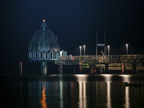 Diving gondola at the illuminated pier in Zingst at night, baltic sea, Mecklenburg-Western