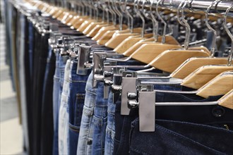 Jeans hanging on hanger in a store