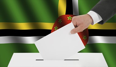 The Dominica flag and the hand with the bulletin about the ballot box