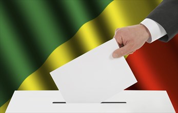 The Congo flag and the hand with the bulletin about the ballot box