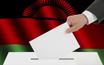 The Malawi flag and the hand with the bulletin about the ballot box