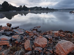 A calm lake with cloudy sky on sunrise