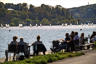 Lake Baldeney in Essen, Ruhr reservoir, sailing boats, café terrace on the shore, Essen, North