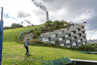 CopenHill, waste incineration plant and artificial ski slope, skiing with a view of the ski lift,