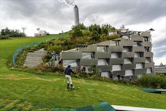 CopenHill, waste incineration plant and artificial ski slope, skiing with a view of the ski lift,