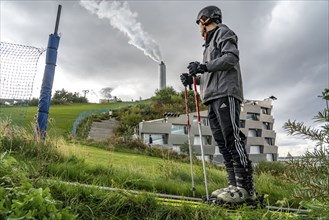 CopenHill, waste incineration plant and artificial ski slope, skiing with a view of the ski lift,