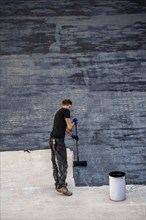 Construction site, application of a bitumen coating to a concrete ceiling, preparation for