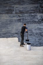 Construction site, application of a bitumen coating to a concrete ceiling, preparation for