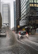 Winter, rainy weather, freezing rain, large puddle, puddle of water, in the city centre, Grosse