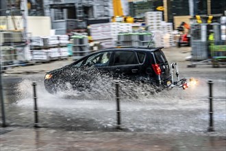 Winter, rainy weather, freezing rain, large puddle, puddle of water, in the city centre, Grosse