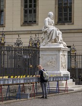 Tourists at the flea market stall in front of Humboldt University, Unter den Linden, Berlin,