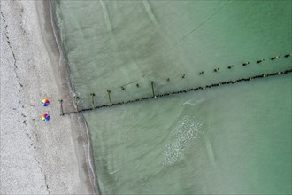 People with colorful umbrella at a groyne, beach of Baltic sea, aerial view, Mecklenburg-Western