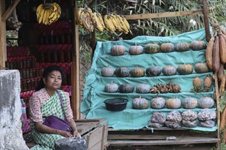 A khasi woman vendor selling home grown vegetables in her roadside stall, in Nongpoh, Meghalaya,