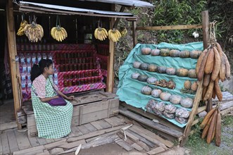 A khasi woman vendor selling home grown vegetables in her roadside stall, in Nongpoh, Meghalaya,