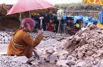 Khasi women breaking stones into different sizes by hammer, in a village in Meghalaya, India on 20