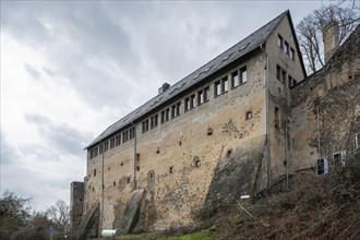 Old high building with windows on top at Ronneburg Castle, Germany during cloudy day, wide angle