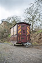 Decorative Trailer made of wood, Christmas market stand on a trailer in front of an old castle,