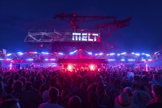 Festival visitors celebrate between bumper cars and excavators at the Melt Festival in Ferropolis