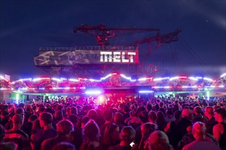 Festival visitors celebrate between bumper cars and excavators at the Melt Festival in Ferropolis