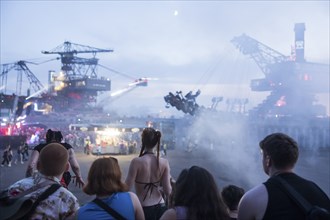 Festival visitors between excavators at the Melt Festival in Ferropolis on 12 July 2024. After a