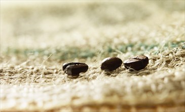 Coffee beans on coffee sack, close-up