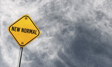 New normal, yellow sign with cloudy sky