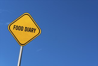 Food diary, yellow sign with blue sky