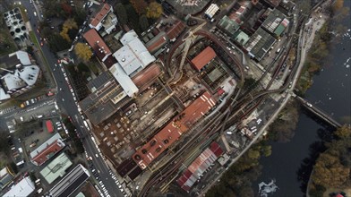 Aerial view of an industrial area within an urban setting featuring various buildings and