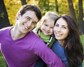 Portrait of happy smiling family in autumn park