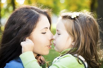 Portrait of woman with baby girl in autumn