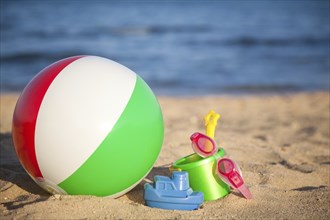 Children's toys for sand and inflatable ball at the beach. Summer vacations concept