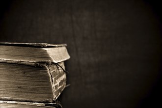 Antique books on grunge dark background. Low key, shallow depth of field