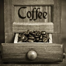 Vintage wooden coffee mill in sepia